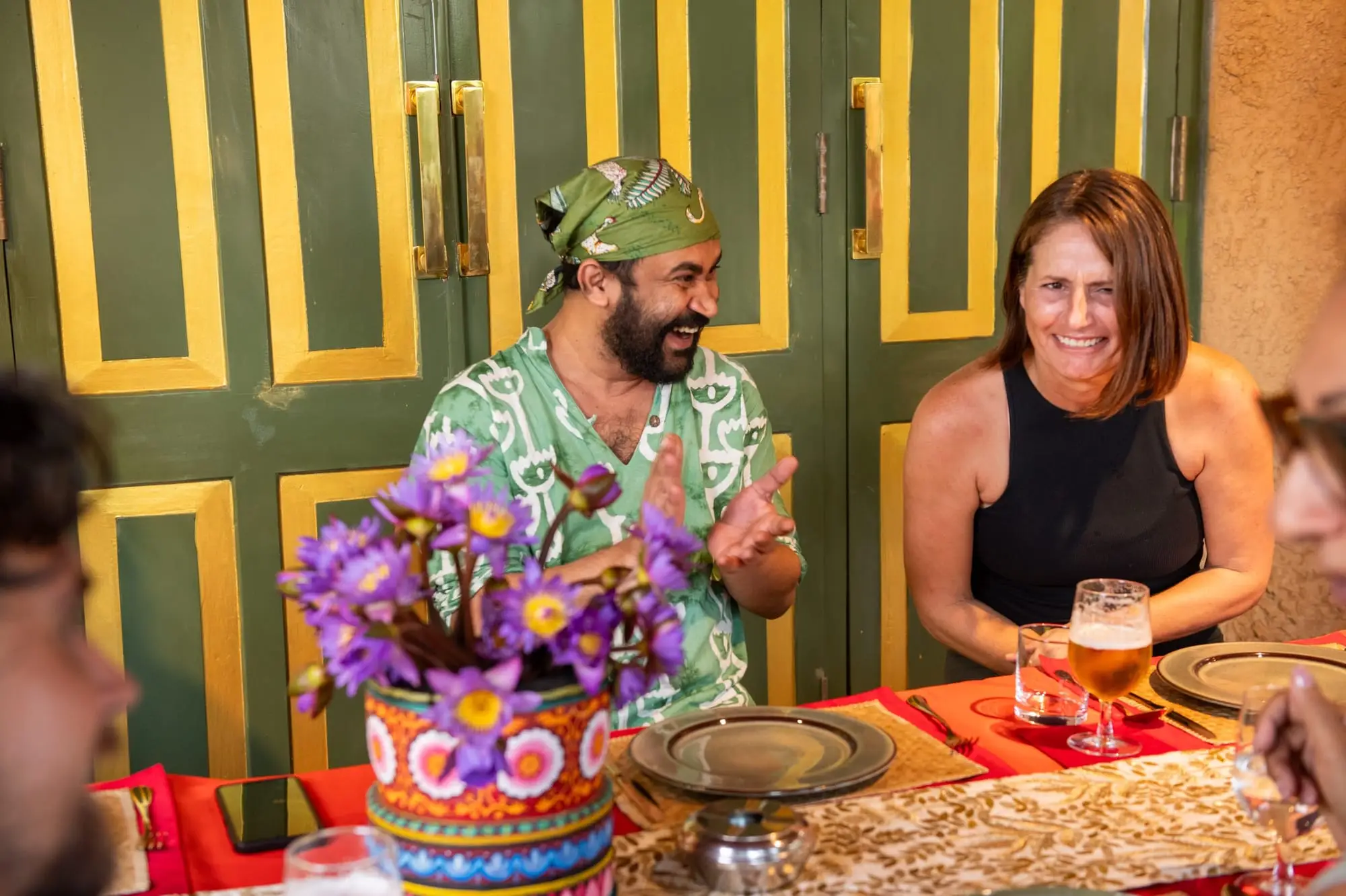 Guests laughing round the table during the feast